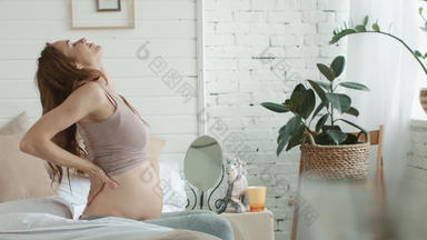 怀孕了女人卧室准妈妈。持有怀孕了肚子首页